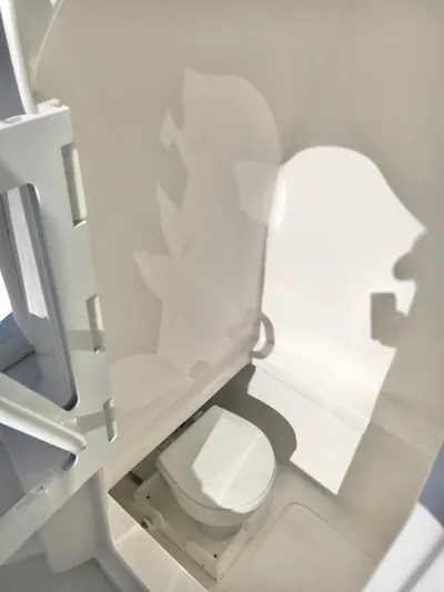  Yacht Photos Pics 2024 Contender 32 ST boat interior with compact marine toilet.