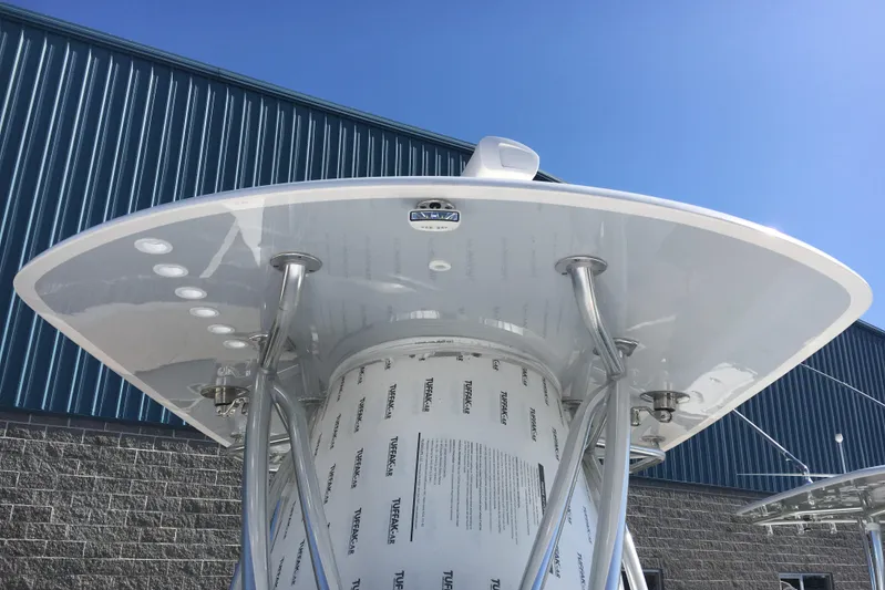  Yacht Photos Pics 2024 Contender 32 ST boat with T-top against blue sky.