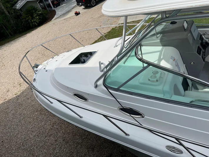  Yacht Photos Pics 2015 Robalo R305 Walkaround boat with white exterior and stainless steel railings.