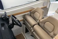 2023 Nimbus W9 boat interior with beige seats and modern steering console.