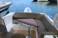 Luxurious 2023 Nimbus W9 boat interior with elegant seating and wooden table by the water.
