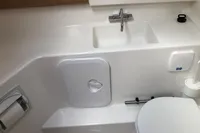 Compact bathroom in 2023 Nimbus W9 boat with sink, toilet, and storage.