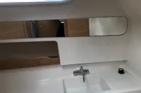 Modern bathroom sink in 2023 Nimbus W9 boat, featuring sleek design and mirror.