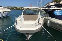 2023 Nimbus W9 boat docked in a marina, surrounded by other vessels.