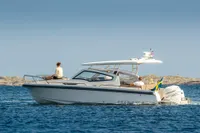 2023 Nimbus W9 boat cruising on calm waters with passengers enjoying the ride.