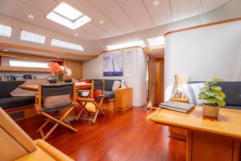 Django Too Yacht Photos Pics Luxurious interior of 1991 Trehard SLOOP 83 yacht with elegant wood finishes.