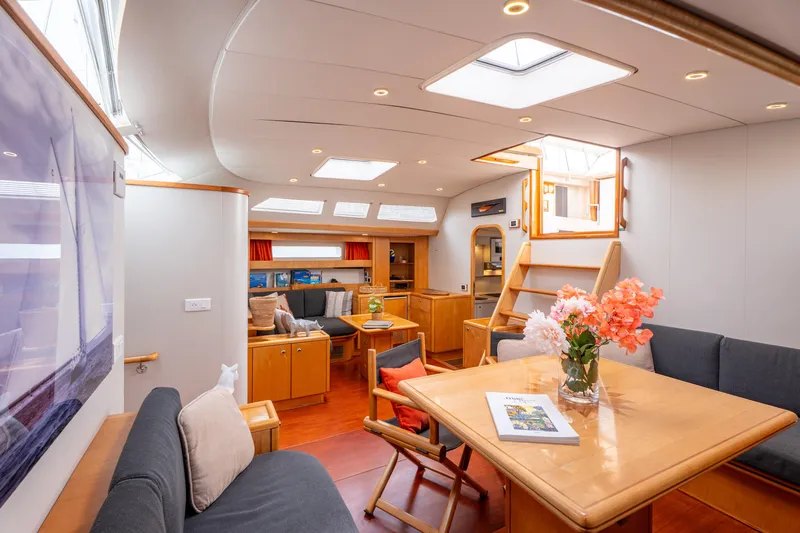 Django Too Yacht Photos Pics Luxurious interior of 1991 Trehard SLOOP 83 yacht with elegant seating and dining area.