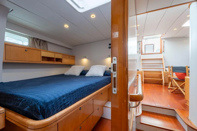 Django Too Yacht Photos Pics Luxurious cabin interior of 1991 Trehard SLOOP 83 yacht with wooden furnishings.