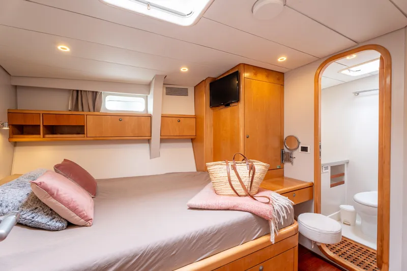 Django Too Yacht Photos Pics Luxurious cabin interior of 1991 Trehard SLOOP 83 yacht with ensuite bathroom.