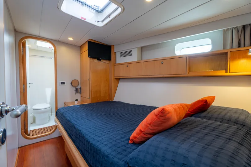 Django Too Yacht Photos Pics Luxurious cabin interior of 1991 Trehard SLOOP 83 yacht with ensuite bathroom.