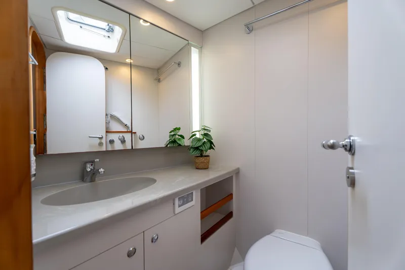 Django Too Yacht Photos Pics Luxurious bathroom interior on 1991 Trehard SLOOP 83 yacht, featuring modern fixtures and decor.