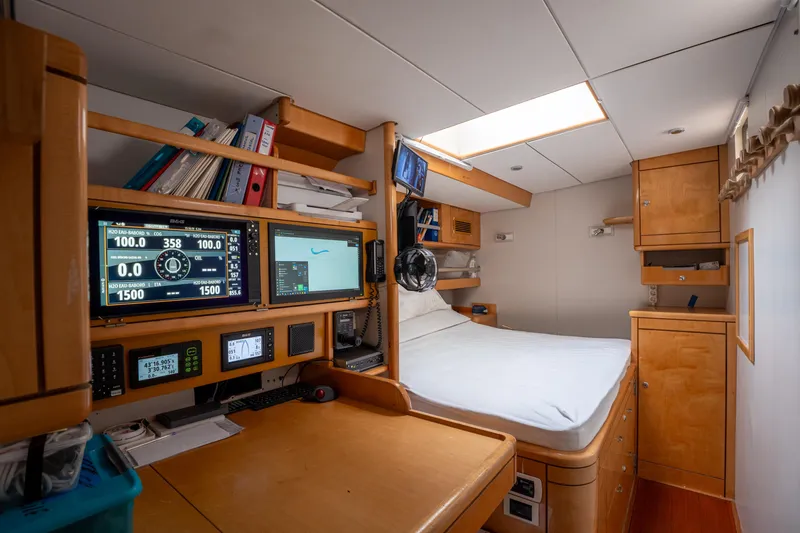 Django Too Yacht Photos Pics Cozy cabin interior of 1991 Trehard SLOOP 83 yacht with navigation equipment and bed.