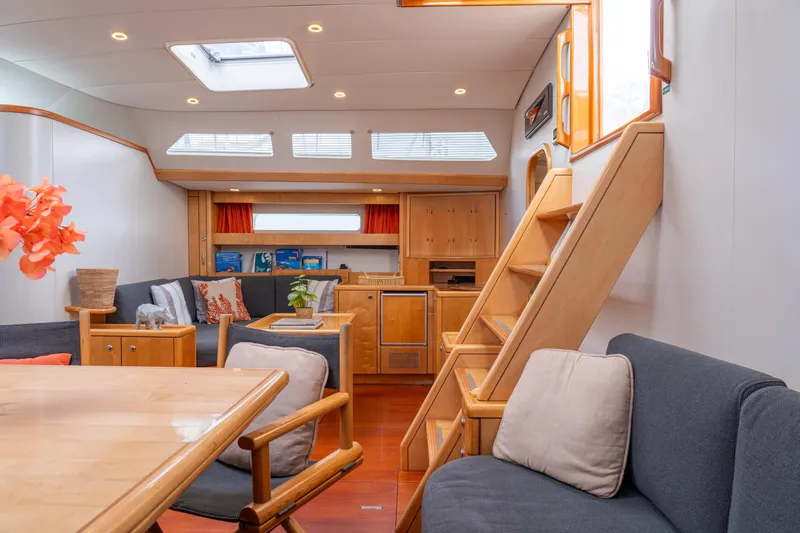 Django Too Yacht Photos Pics Luxurious interior of 1991 Trehard SLOOP 83 yacht with modern furnishings and wooden accents.