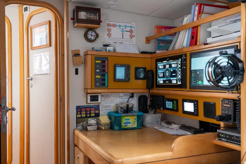 Django Too Yacht Photos Pics Navigation station inside 1991 Trehard SLOOP 83 yacht, featuring control panels and equipment.