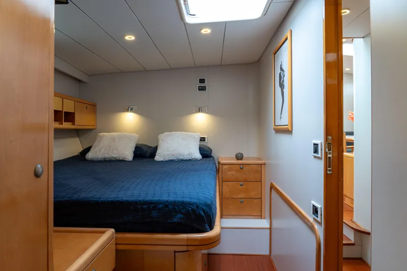 Django Too Yacht Photos Pics Luxurious cabin interior of 1991 Trehard SLOOP 83 yacht with cozy bed and modern decor.