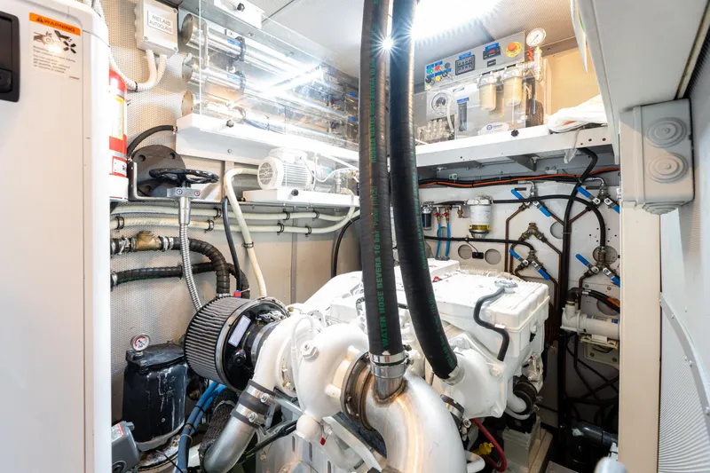 Django Too Yacht Photos Pics Engine room of 1991 Trehard SLOOP 83 yacht, showcasing mechanical components and piping.