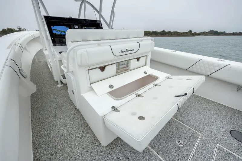Hoo Hunter Yacht Photos Pics 2012 SeaHunter 37 Tournament boat interior with open storage compartment, white seating, and control panel.