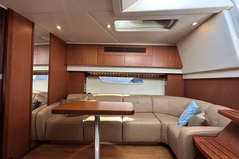 Life's Grande Yacht Photos Pics Luxurious interior of 2012 Sea Ray 470 Sundancer yacht with leather seating and wooden accents.