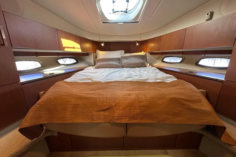 Life's Grande Yacht Photos Pics Luxurious cabin interior of 2012 Sea Ray 470 Sundancer yacht with cozy bedding.