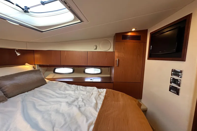 Life's Grande Yacht Photos Pics Luxurious cabin interior of 2012 Sea Ray 470 Sundancer yacht with bed and TV.