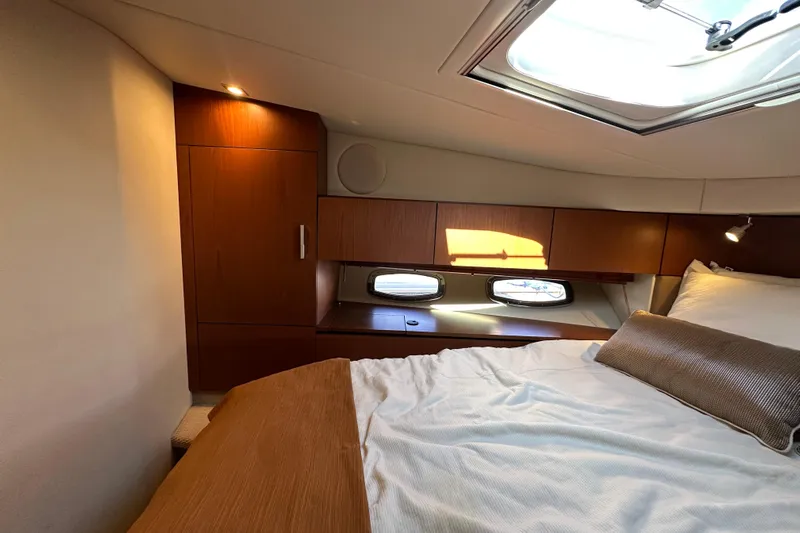 Life's Grande Yacht Photos Pics Luxurious cabin interior of 2012 Sea Ray 470 Sundancer yacht with skylight and wooden cabinetry.