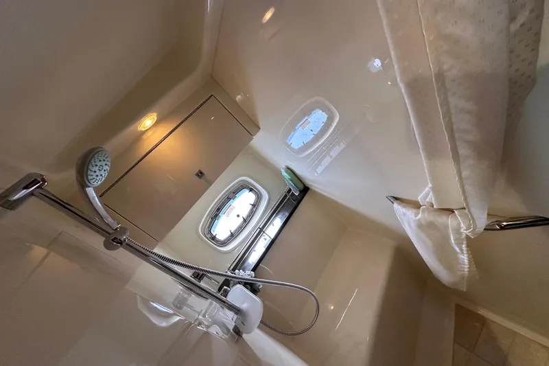 Life's Grande Yacht Photos Pics Interior of 2012 Sea Ray 470 Sundancer yacht bathroom with shower and porthole window.