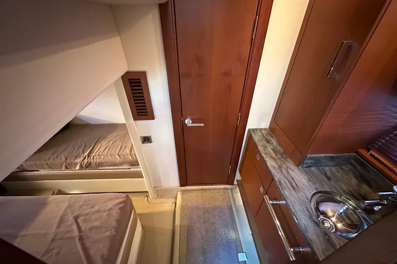 Life's Grande Yacht Photos Pics 2012 Sea Ray 470 Sundancer cabin interior with wood finish and compact sink area.