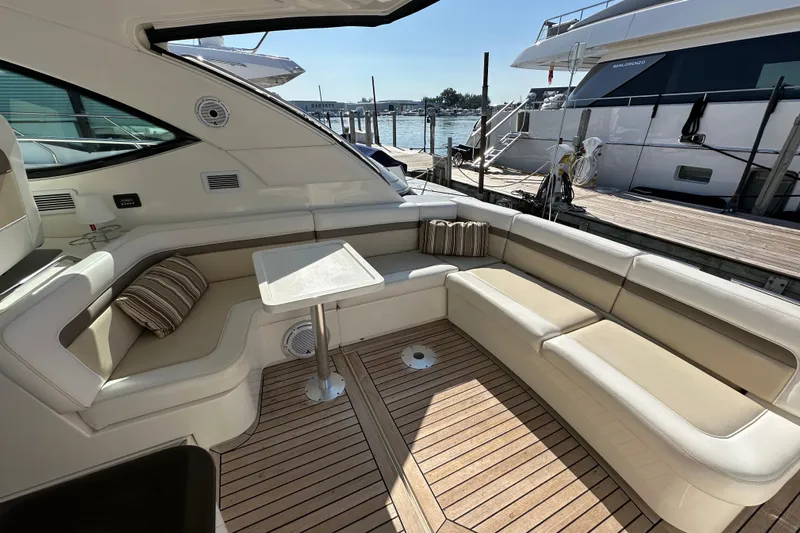 Life's Grande Yacht Photos Pics Luxurious seating area on a 2012 Sea Ray 470 Sundancer yacht, docked at a marina.