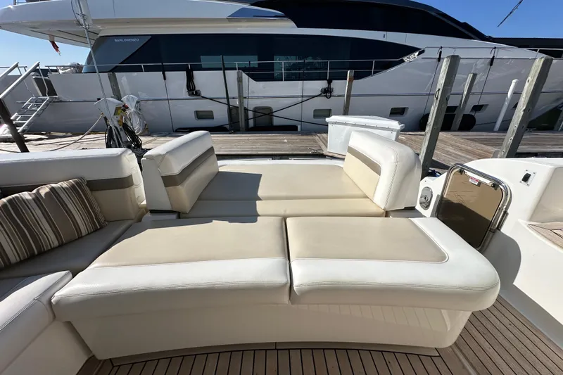 Life's Grande Yacht Photos Pics Luxurious seating on 2012 Sea Ray 470 Sundancer yacht, docked beside another vessel.