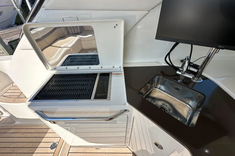 Life's Grande Yacht Photos Pics 2012 Sea Ray 470 Sundancer yacht kitchen with grill, sink, and countertop.