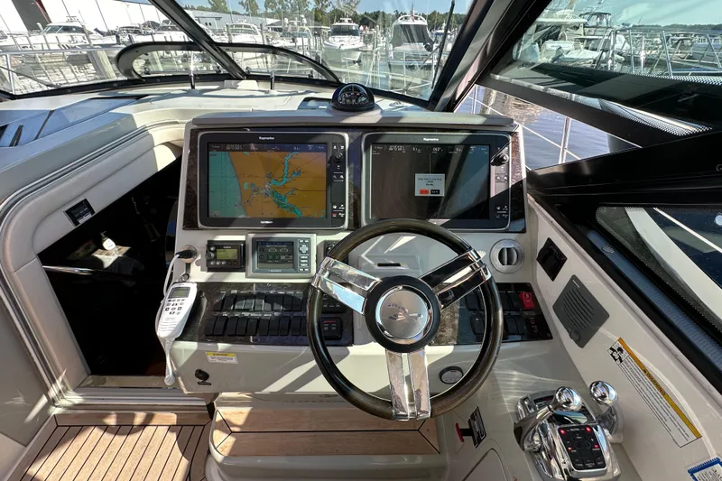Life's Grande Yacht Photos Pics Interior helm of 2012 Sea Ray 470 Sundancer with navigation screens and steering wheel.