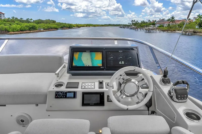 Evexias Yacht Photos Pics Cockpit view of 2020 Azimut S7 FLY yacht with navigation screens and steering wheel.