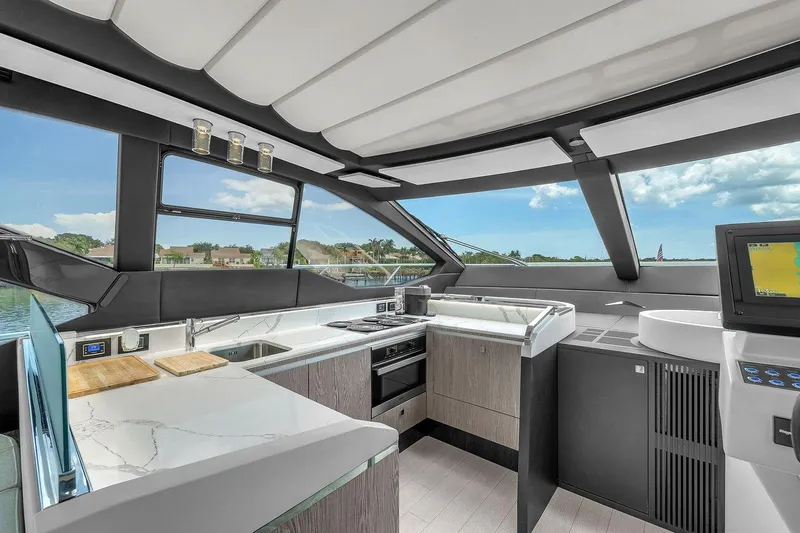 Evexias Yacht Photos Pics Luxurious interior of 2020 Azimut S7 FLY yacht with modern kitchen and panoramic windows.