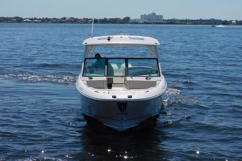 Tempus Yacht Photos Pics 2016 Pursuit DC 325 Dual Console boat cruising on open water.