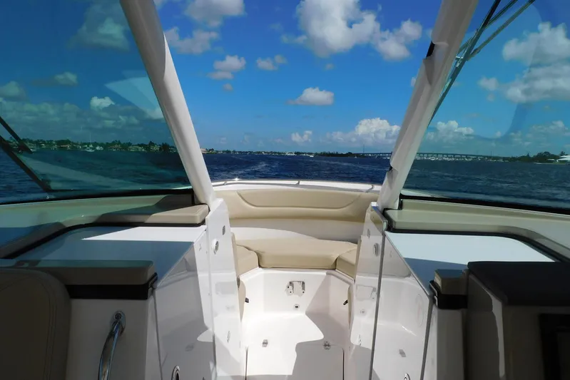 Tempus Yacht Photos Pics 2016 Pursuit DC 325 Dual Console boat interior with ocean view and blue sky.