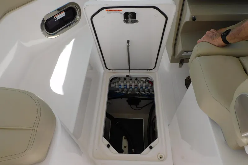 Tempus Yacht Photos Pics 2016 Pursuit DC 325 Dual Console boat storage compartment with open hatch and visible wiring.