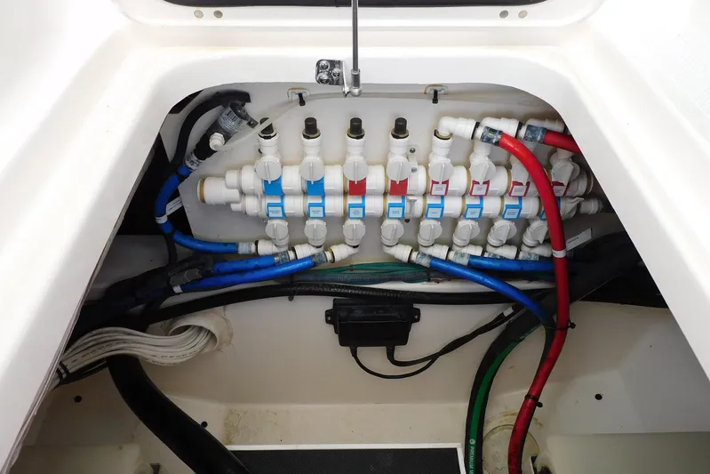 Tempus Yacht Photos Pics 2016 Pursuit DC 325 Dual Console boat plumbing system with labeled valves and colored hoses.