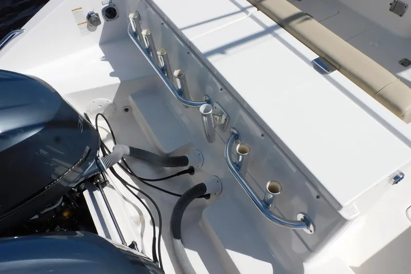 Tempus Yacht Photos Pics 2016 Pursuit DC 325 Dual Console boat interior with rod holders and engine.