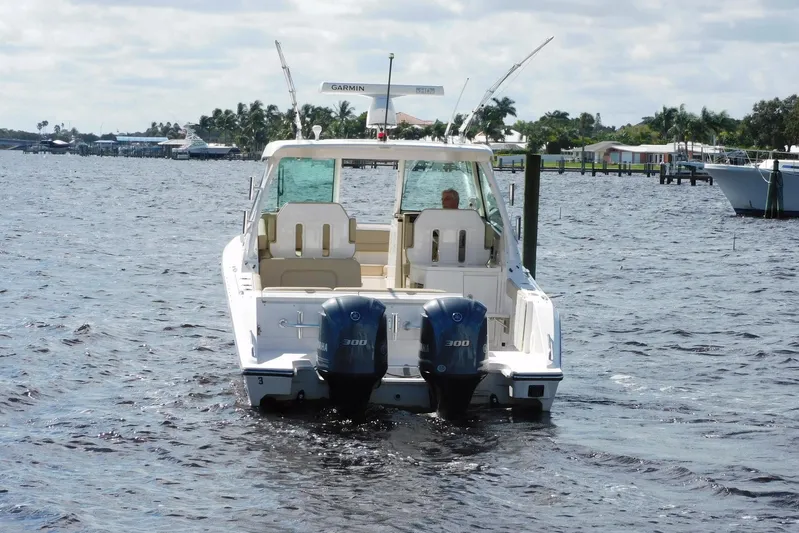 Tempus Yacht Photos Pics 2016 Pursuit DC 325 Dual Console boat on water with twin Yamaha engines.