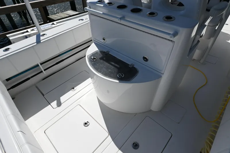  Yacht Photos Pics 2023 Contender 32ST boat deck with storage compartments and seating.