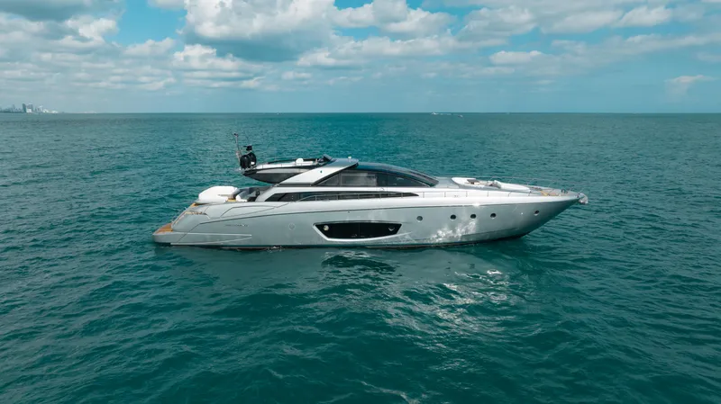 Purosangue Yacht Photos Pics Luxurious 2014 Riva 86' DOMINO yacht cruising on open sea under a partly cloudy sky.