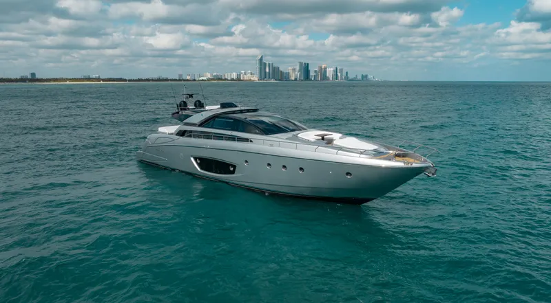 Purosangue Yacht Photos Pics Luxury 2014 Riva 86' DOMINO yacht cruising near city skyline on a sunny day.