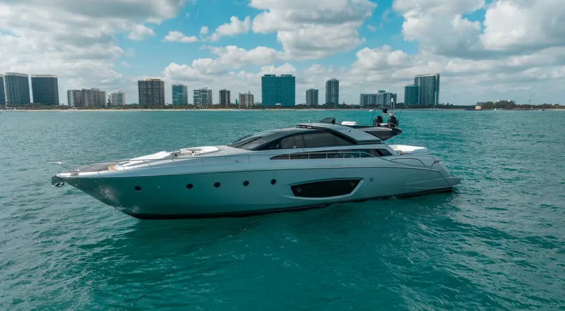 Purosangue Yacht Photos Pics Luxurious 2014 Riva 86' DOMINO yacht cruising near city skyline on a sunny day.