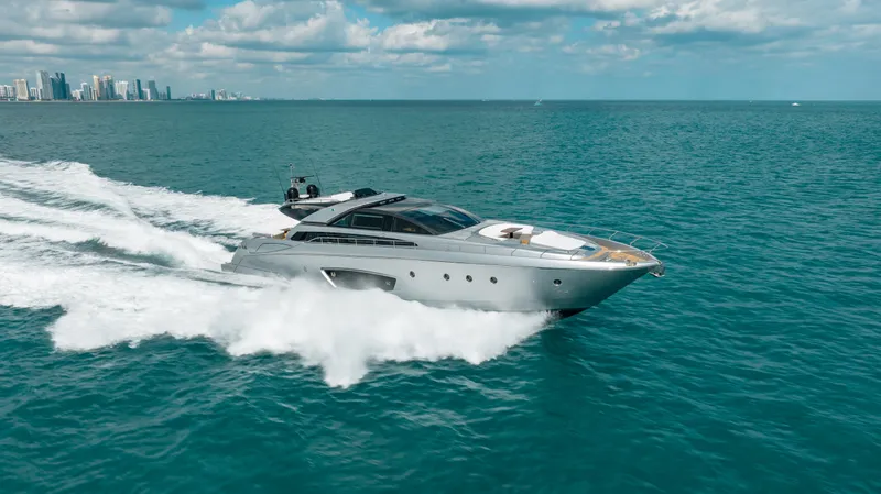 Purosangue Yacht Photos Pics Luxury 2014 Riva 86' DOMINO yacht cruising on open sea with city skyline.