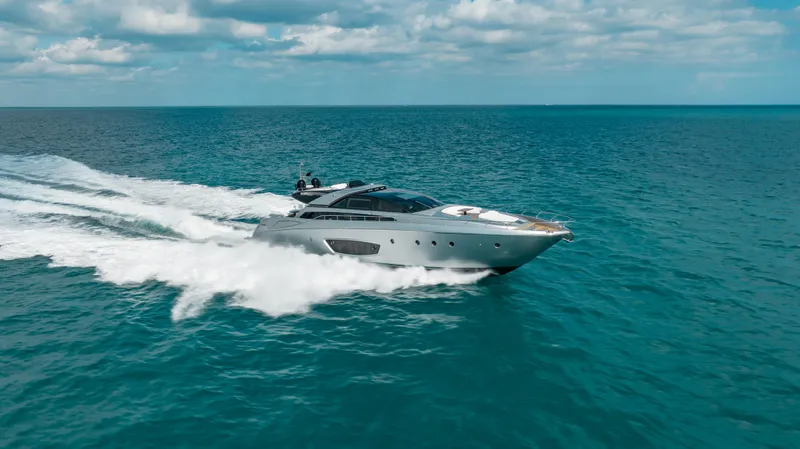 Purosangue Yacht Photos Pics Luxurious 2014 Riva 86' DOMINO yacht cruising on open sea under cloudy sky.