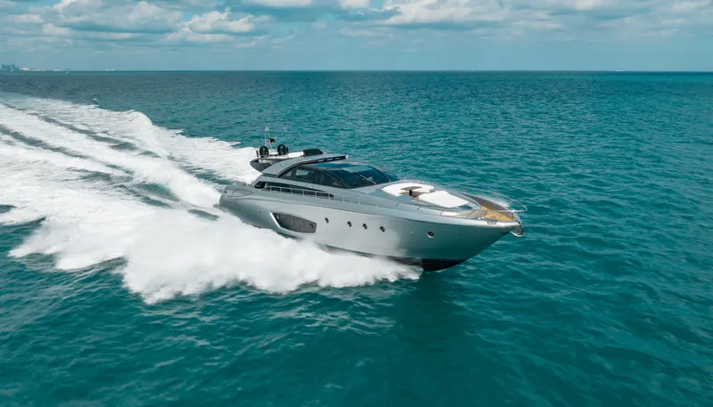 Purosangue Yacht Photos Pics Luxurious 2014 Riva 86' DOMINO yacht cruising on open sea under clear skies.