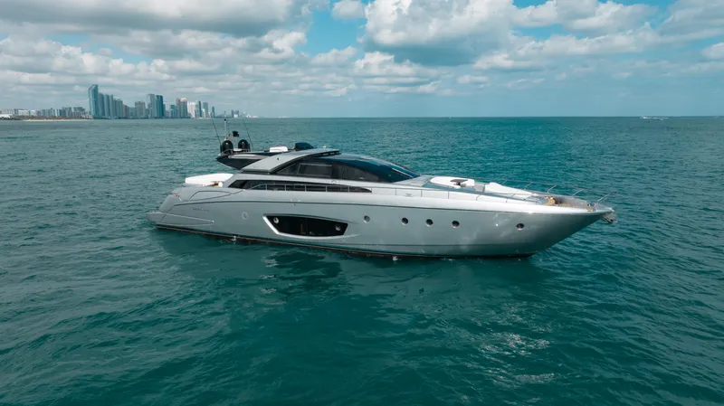 Purosangue Yacht Photos Pics Luxury 2014 Riva 86' DOMINO yacht cruising on open sea with city skyline backdrop.