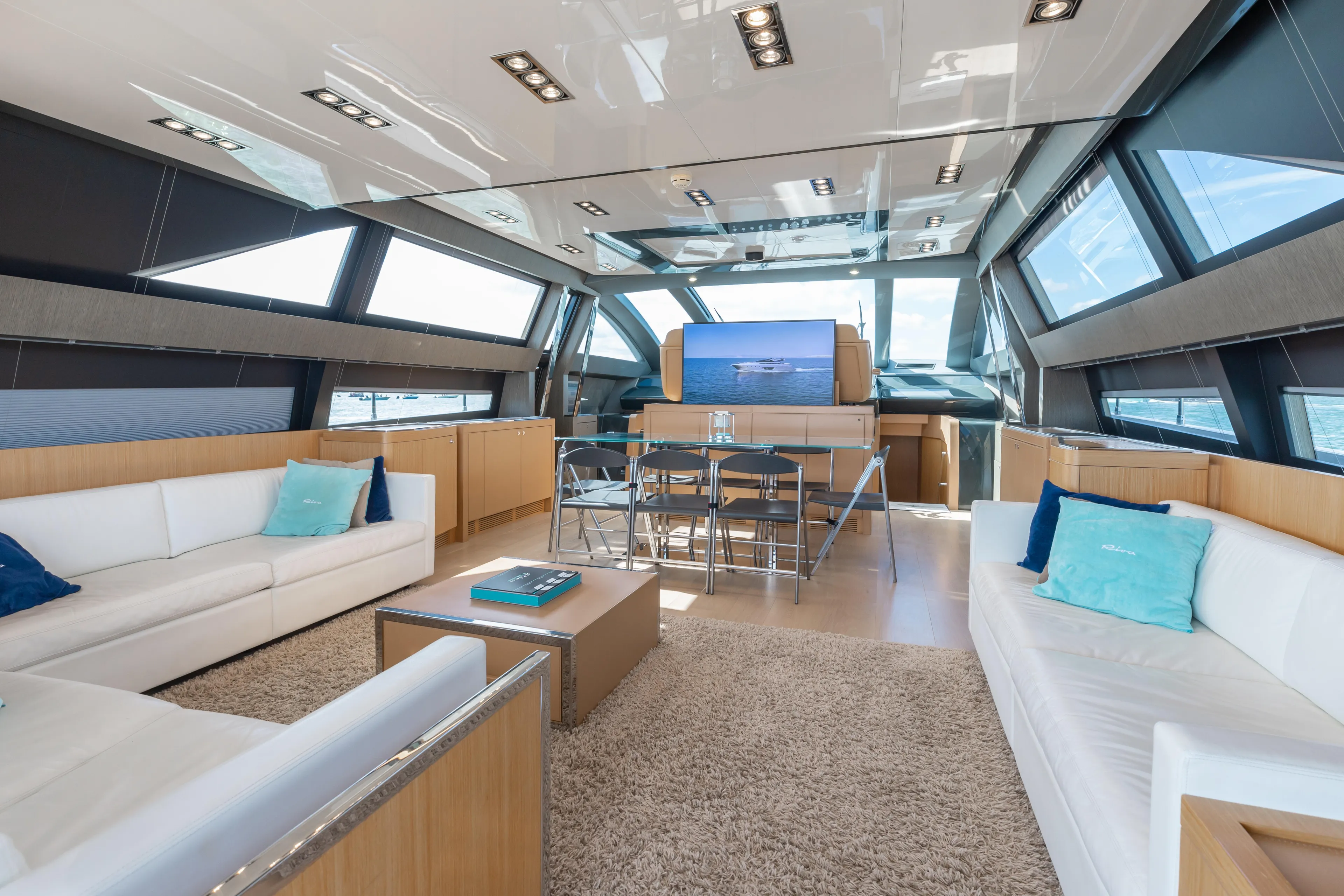 Purosangue Yacht Photos Pics Luxurious interior of 2014 Riva 86' DOMINO yacht with modern furnishings and panoramic windows.