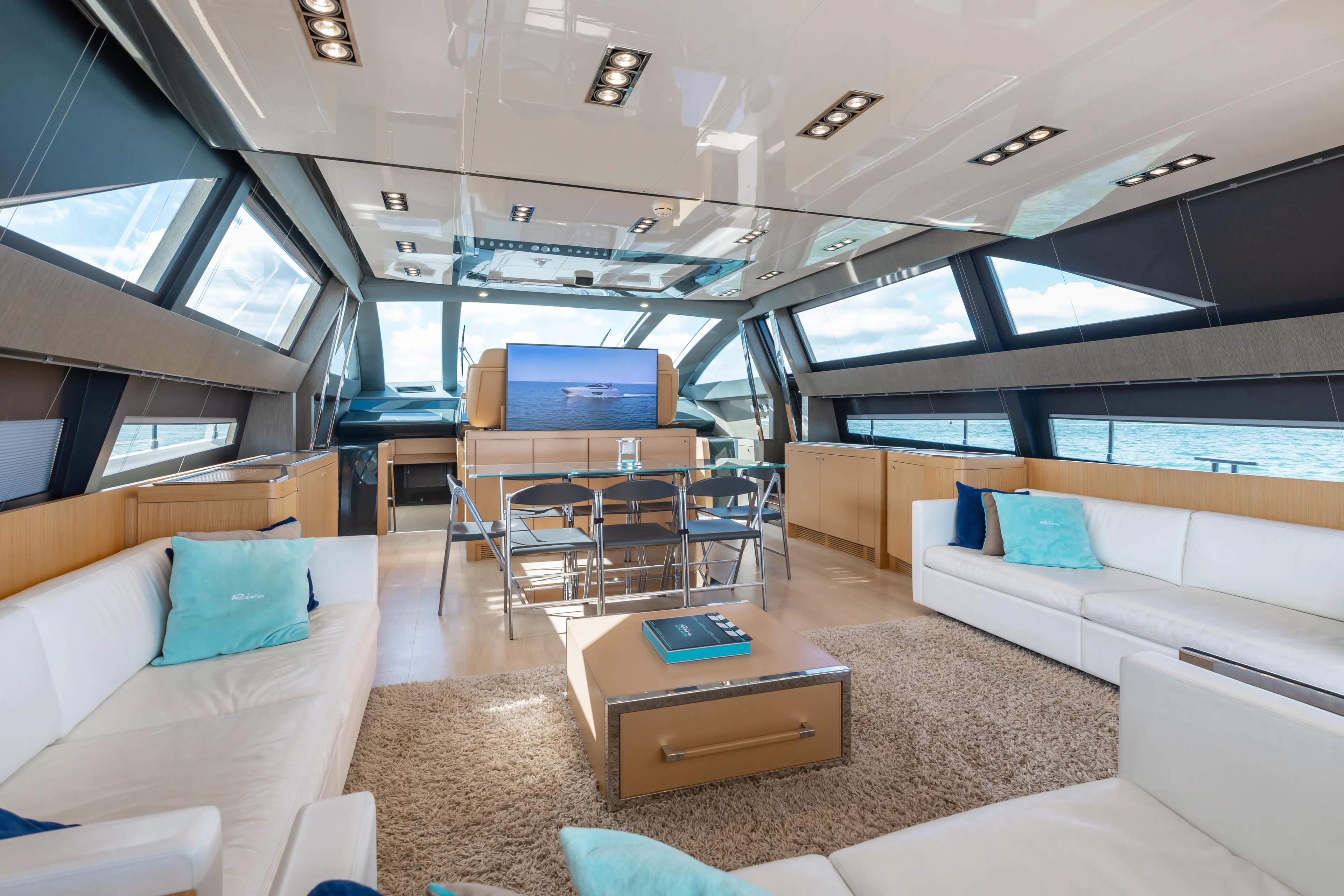Purosangue Yacht Photos Pics Luxurious interior of 2014 Riva 86' DOMINO yacht with modern furnishings and panoramic windows.