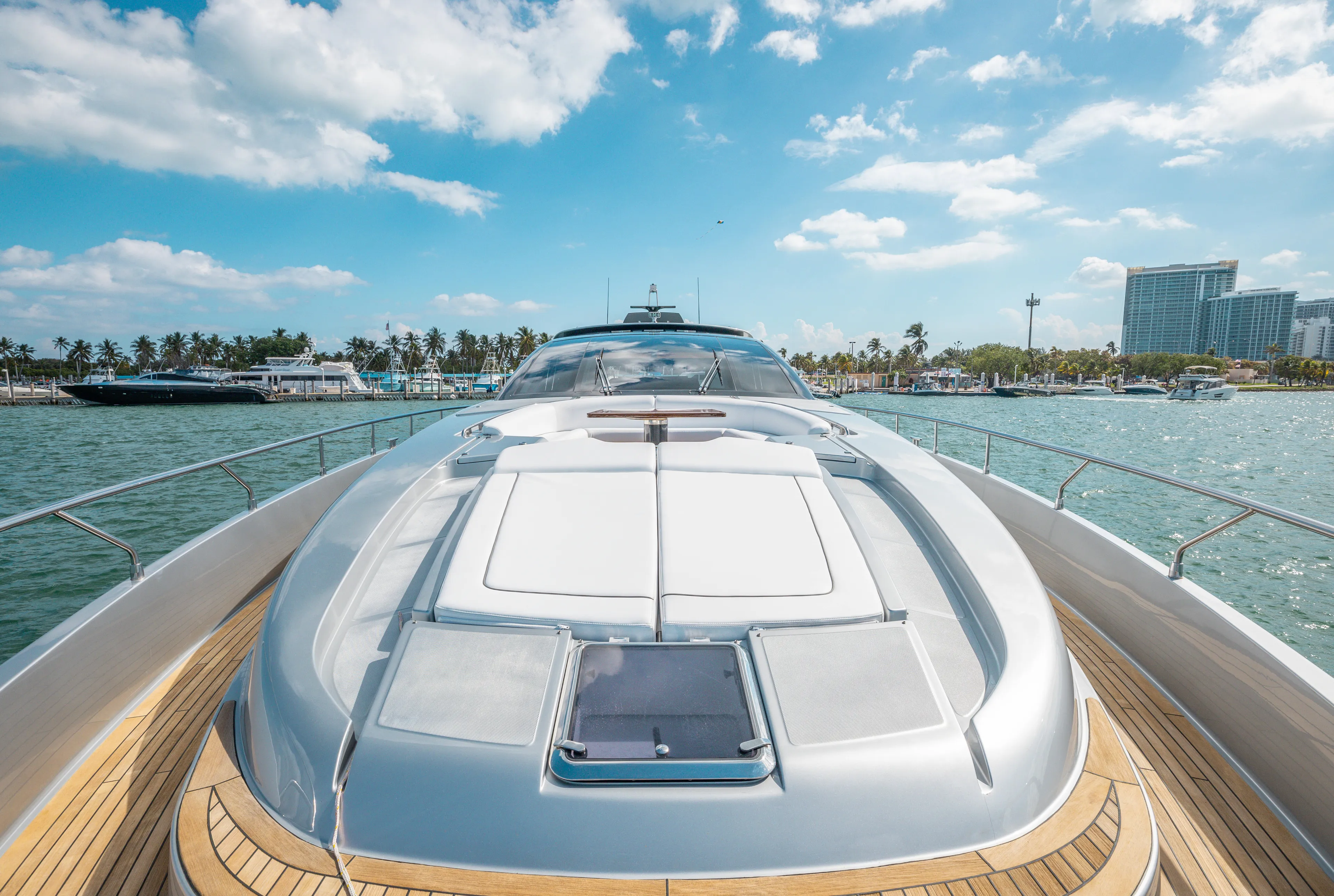 Purosangue Yacht Photos Pics Luxurious 2014 Riva 86' DOMINO yacht on serene waters under a bright blue sky.